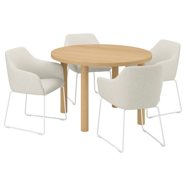 A round oak dining set with four cream-colored armchairs.