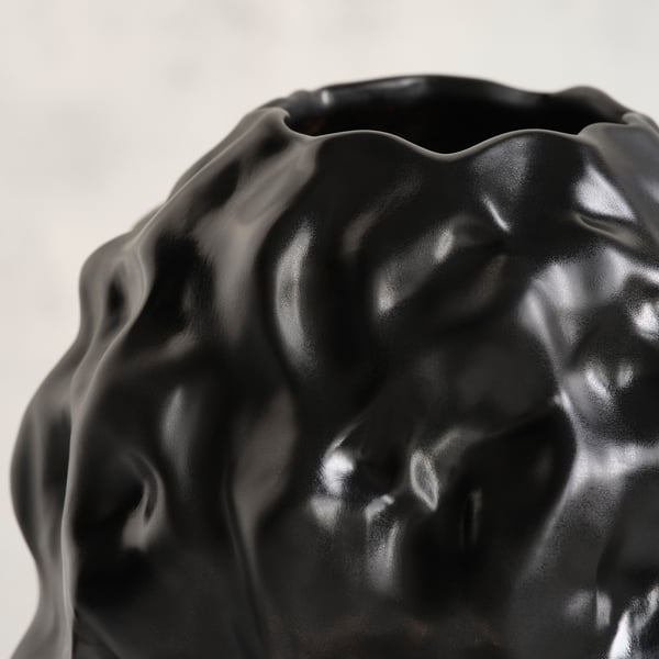 Sculptural black stoneware vase with glossy, bubbly texture.