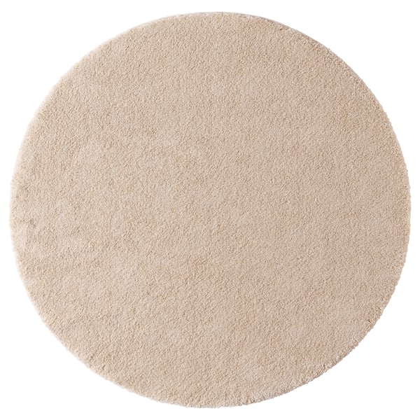 Circular, beige STOENSE rug with soft, thick pile; harmony-inducing sheen.