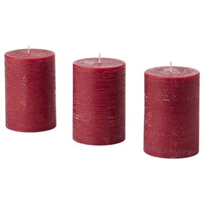 Three red candles, standing upright, cylindrical shape, textured design.