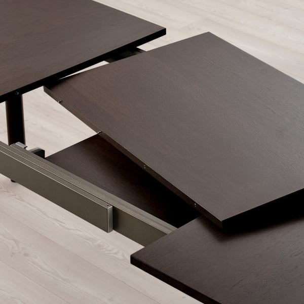 Extendable dining table with hidden leaves. , dark wood surface, steel legs and frame.