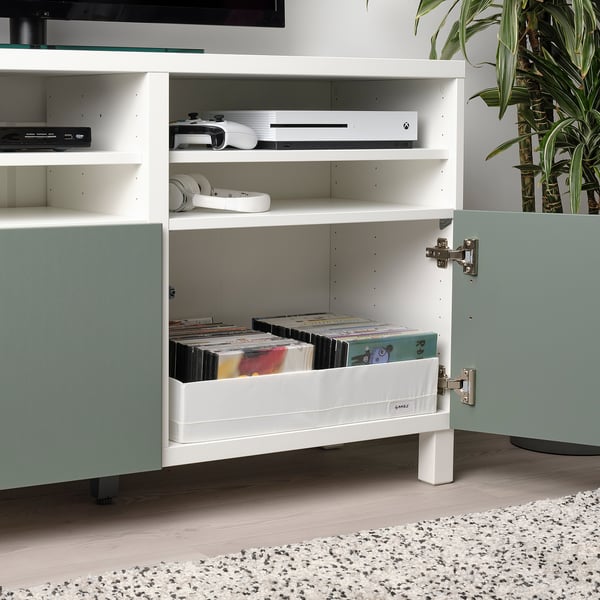 White cabinet stores vinyl records, gaming consoles, and headphones, part of the STUK series.