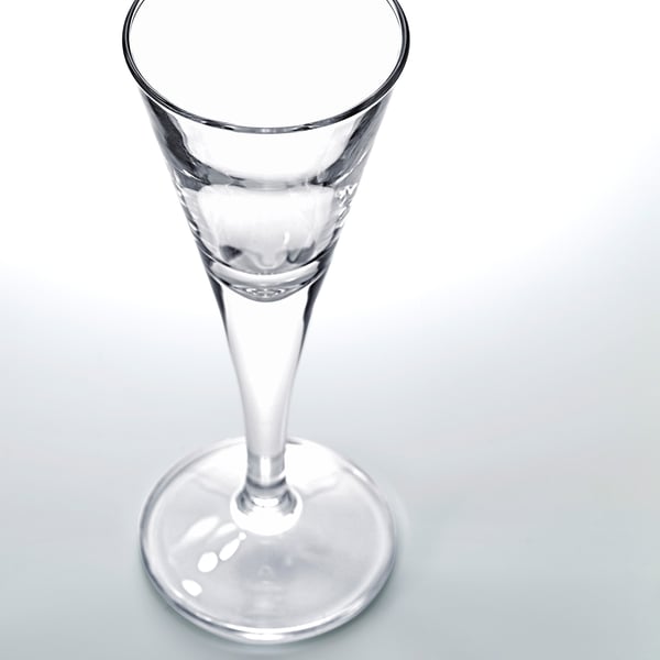 Clear glass snaps glass on a plain surface, petite and elegant design.