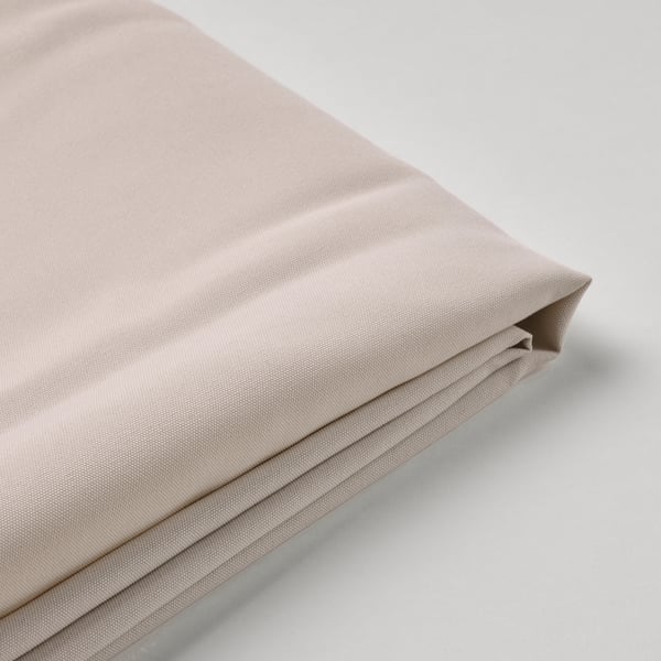 A neatly folded, beige-colored fabric. It appears to be of high quality, with a smooth texture and even stitching, designed for a parasol canopy.