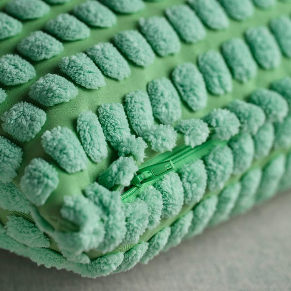 Light green throw pillow cover with soft, textured pattern and subtle colour variations, featuring a durable zip.