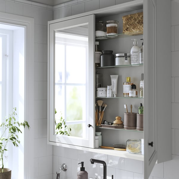 Bathroom cabinet with mirror, holding toiletries and makeup, wall-mounted, shallow design.