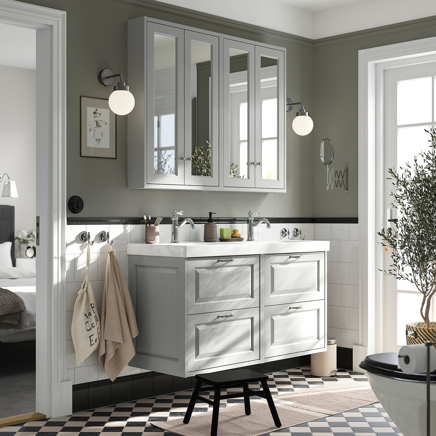 A modern bathroom with a grey TÄNNFORSEN double vanity, featuring mirrored cabinets, double basins, and a sleek design.