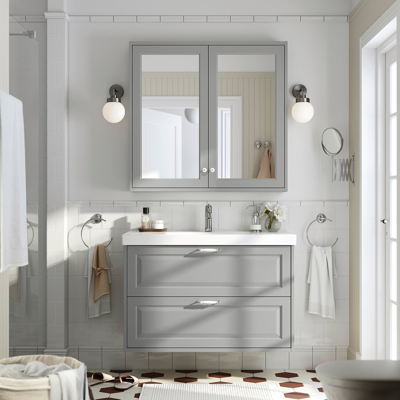 Modern grey bathroom: TÄNNFORSEN vanity, mirror, towels, sink & tap. Light, spacious, & functional.
