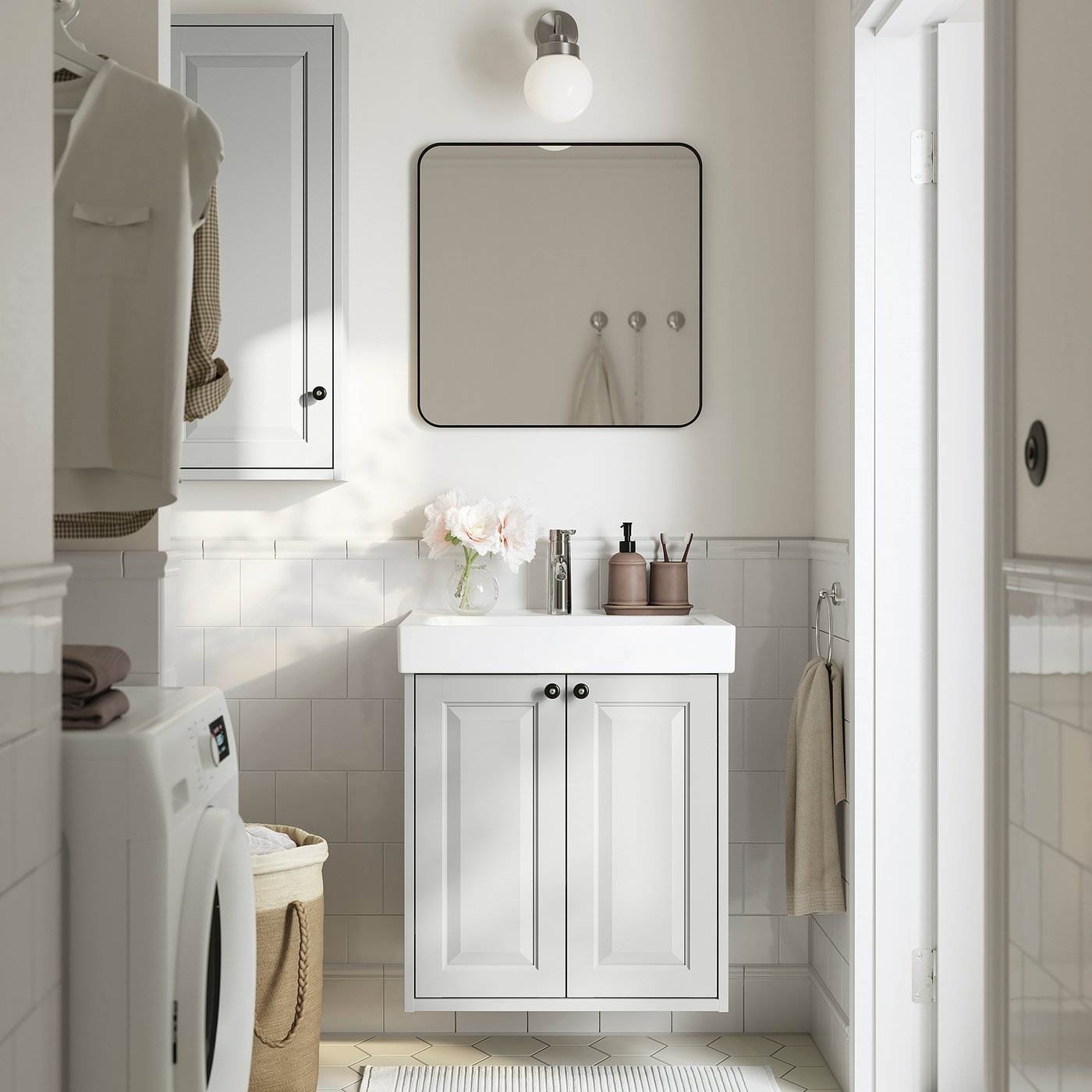 Modern compact bathroom with TÄNNFORSEN cabinet, sink, mirror, and grey towels