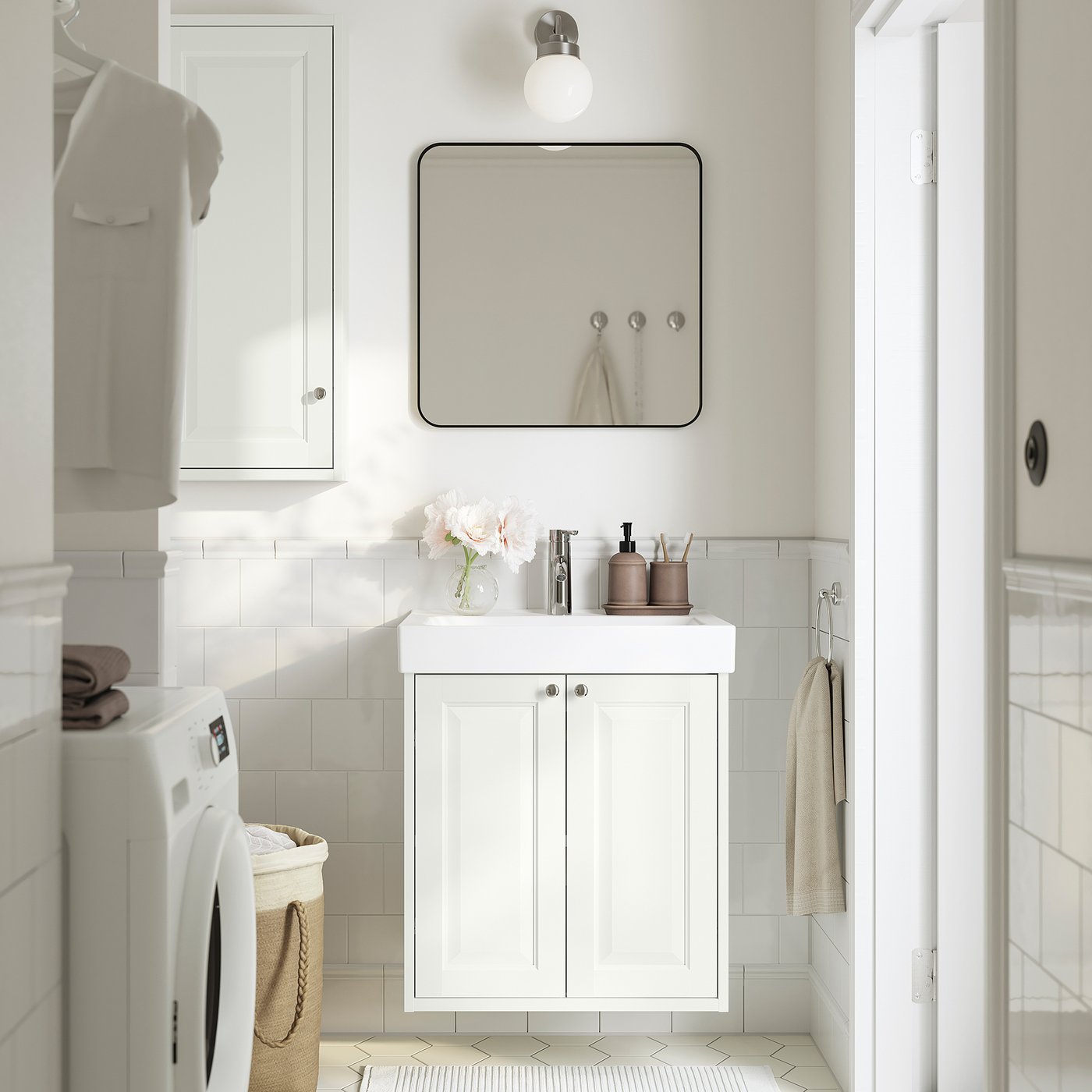 White vanity with sink, mirror, and storage in bathroom.