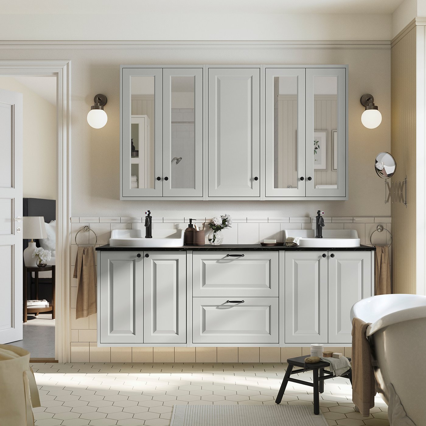 Modern bathroom with white TÄNNFORSEN double vanity, large mirror, two sinks, and wall lamps.