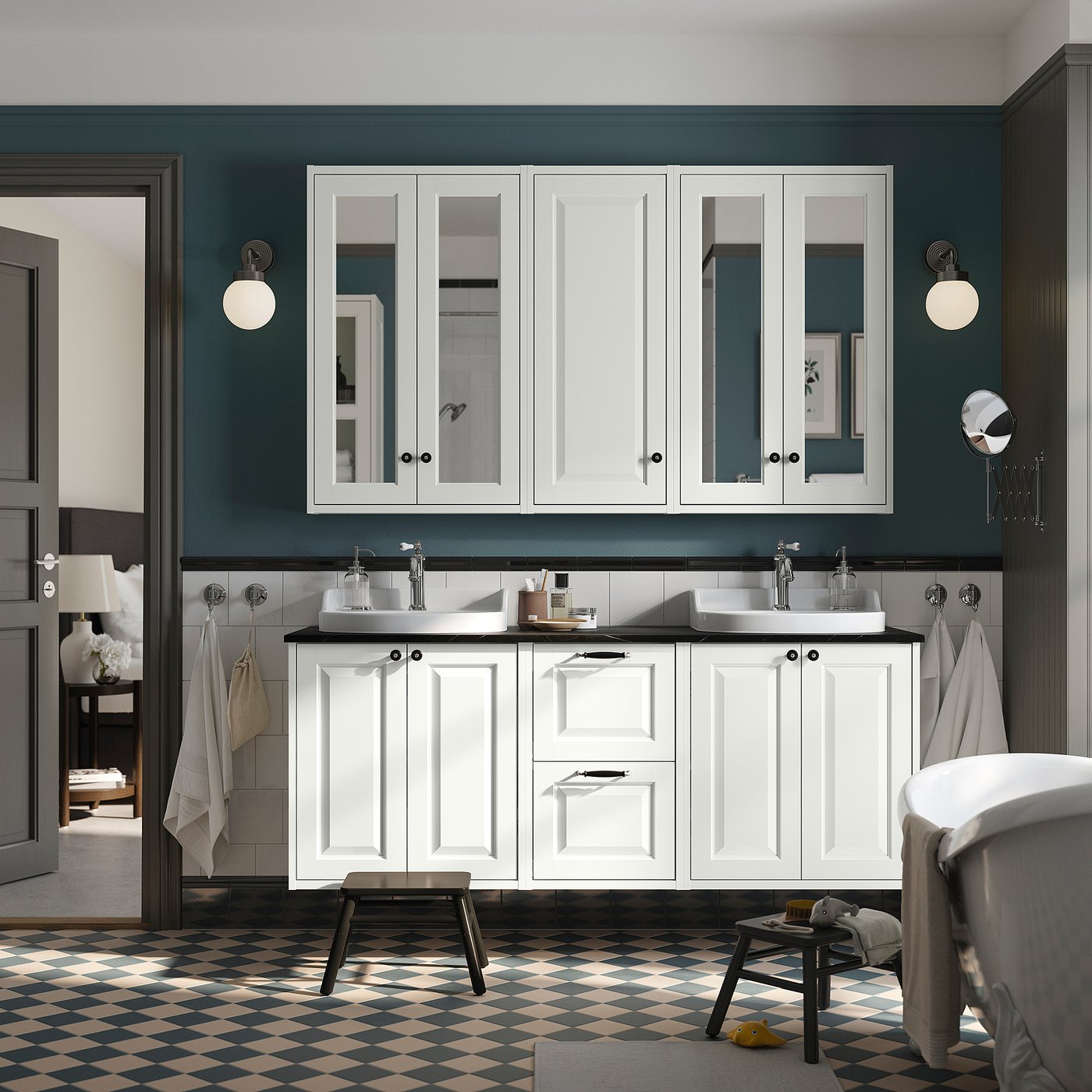 Modern bathroom with TÄNNFORSEN vanity, double sinks, dark teal walls, chequered floor, and wall lights.