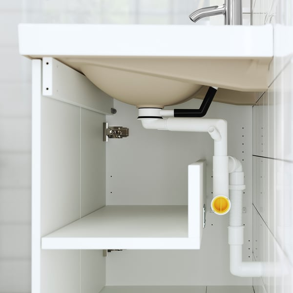 White under-sink cabinet with pipes and shelf. Part of TÄNNFORSEN bathroom series.