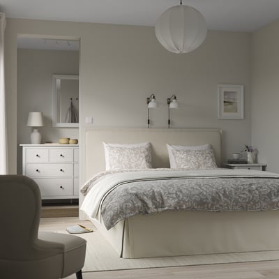 Modern bedroom with TÄRNKULLEN bed, patterned linens, cushioned headboard, and minimalist decor.
