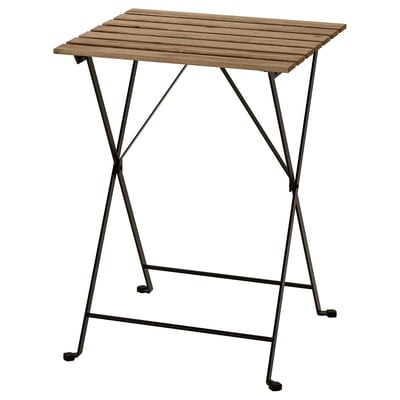 A TÄRNÖ outdoor table with a wooden top and black metal legs, foldable design.