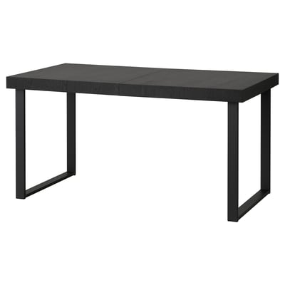 A TARSELE black extendable dining table with metal legs, featuring a sleek, industrial design.