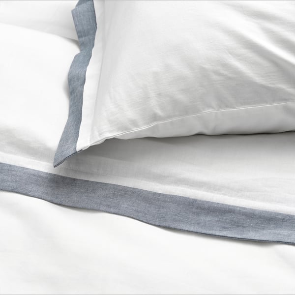 Crisp, white duvet set with neat blue trim, made of soft organic cotton, showing quality stitching and elegant design.