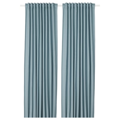 Two solid blue curtains hang side by side. Simple, elegant design with rod pocket top. Ideal for privacy and light control.