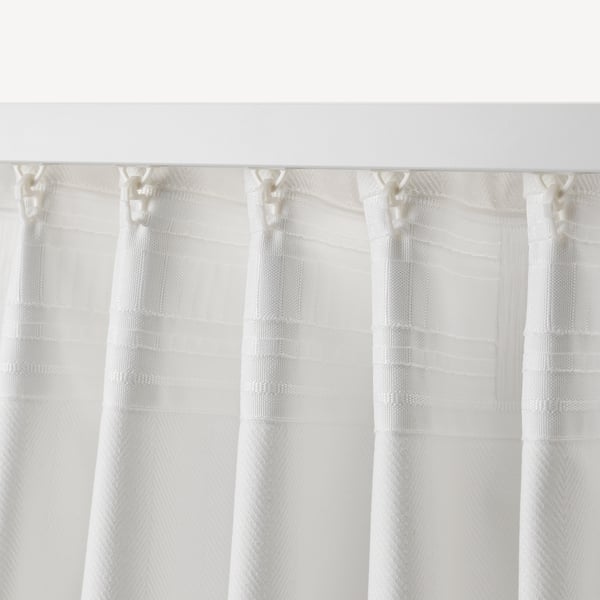 Sheer curtains with pleat hooks, diffuse light, provide privacy.