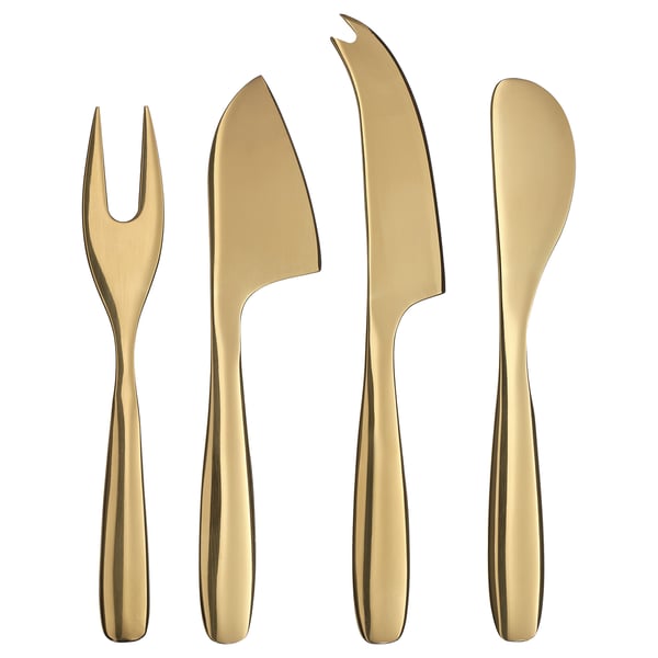 Four sleek, brass-colored serving utensils: fork, knife, spatula, and cheese knife, each with elegant, metallic stainless steel handles and tips.