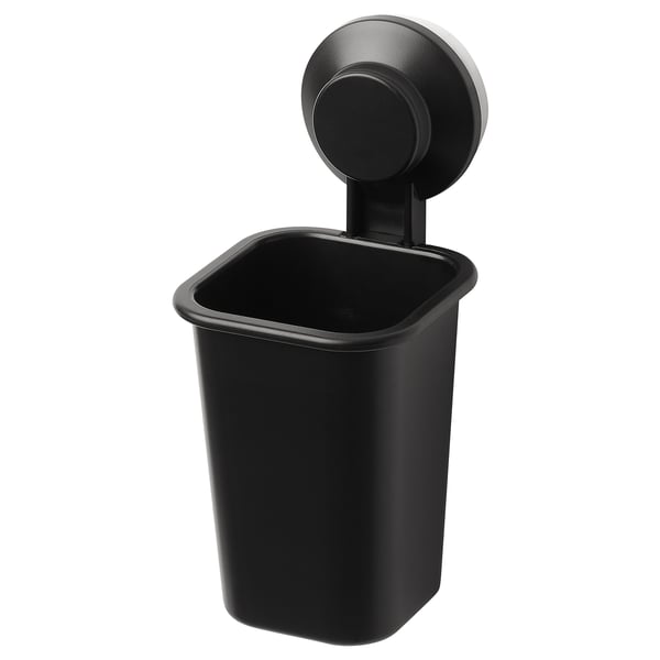 Black TISKEN wall-mounted toothbrush holder, round top, rectangular body, suction-cup attachment.