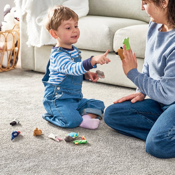 A child and adult play with finger puppets, encouraging storytelling and imagination.