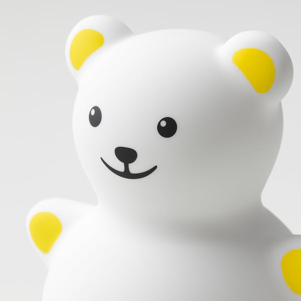 Cute white teddy bear night light with bright yellow ears & feet, friendly face.
