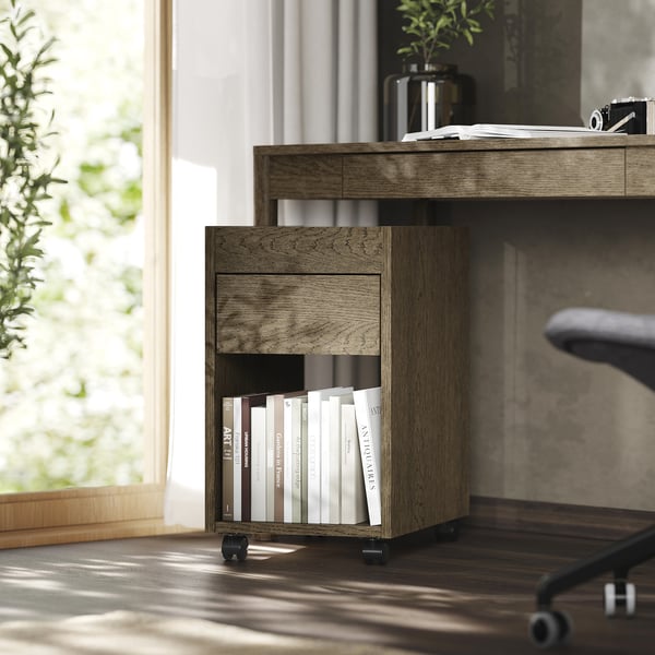 Home office with TONSTAD brown wooden storage. Books under cabinet; potted plant, desk, window.