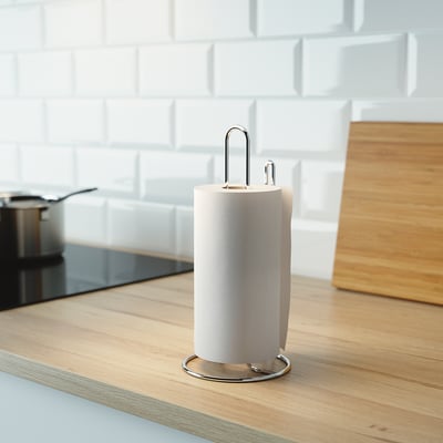 Silver kitchen roll holder with a support bar on a wooden counter, holding a white paper roll.