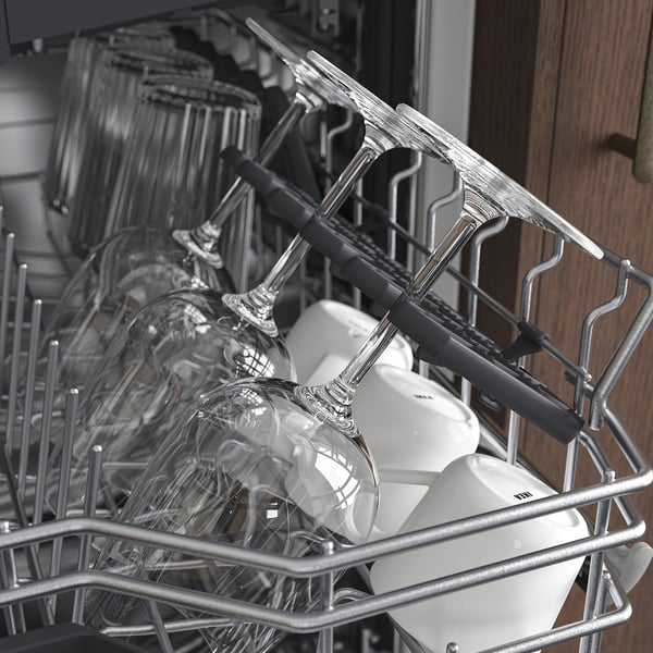 Dishwasher with adjustable baskets. Glasses and cutlery holders shown. Foldable racks for large items.