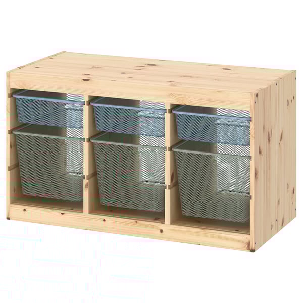 An ikea TROFAST wooden storage unit with blue mesh bins. The light pine unit has three compartments with two bins each, suitable for organizing items.