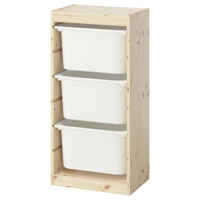 An ikea TROFAST storage unit with white plastic bins in a light wooden frame.