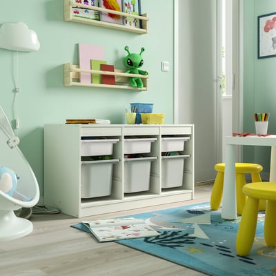 Playroom with TROFAST storage unit, light green, wooden, low, cubes for storage, near yellow chairs and open door.