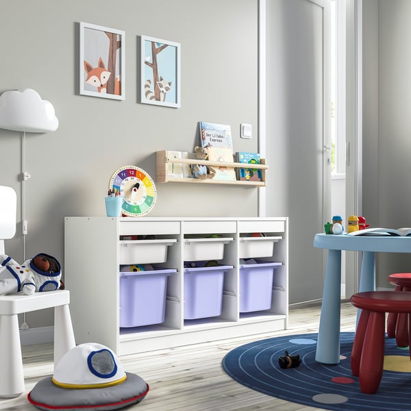 Playroom with white TROFAST storage unit, purple bins, books, colourful wall art, toy table, and astronaut toys.