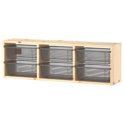 Wooden TROFAST wall shelf with three metal mesh drawers.