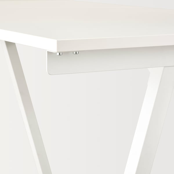 Close-up of trotton desks clean white surface & sturdy metal connectors.