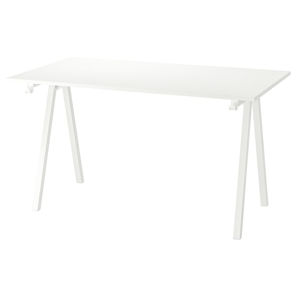 A white trottem table with a rectangular top and four angled legs.