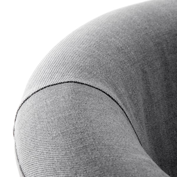 Close-up of a sleek, modern armchair cushion in neutral tones, showcasing its smooth fabric and precise stitching.