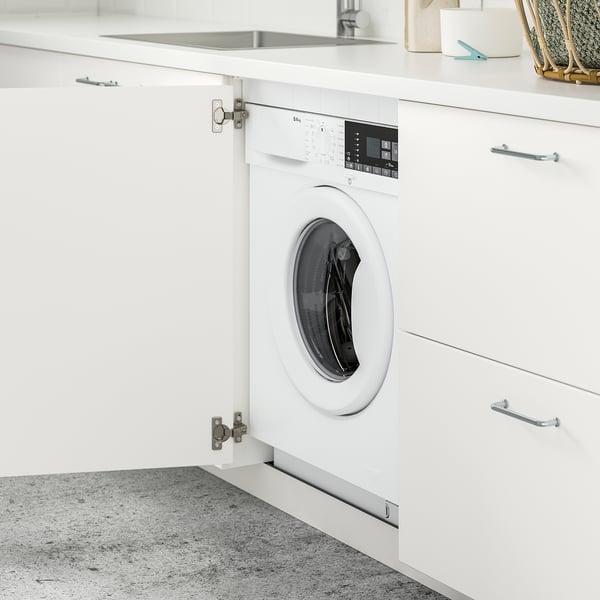 Built-in washer/dryer with steam function visible in a sleek, modern kitchen cabinet setup.
