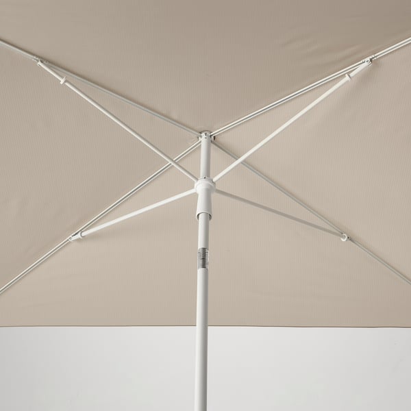 White folding beach parasol with strong metal ribs, solid hub, and adjustable tilt, ready for use.