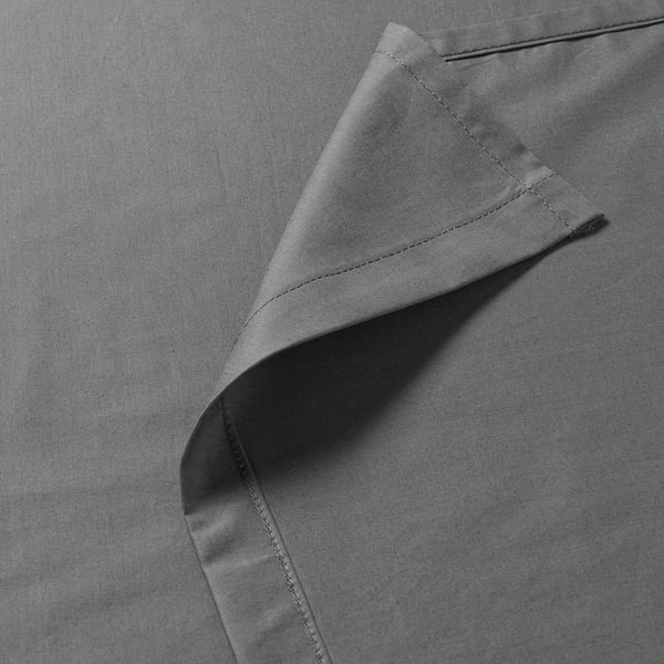 Folded sheet showing fine weave and precise stitching. Quality detail of luxurious, breathable fabric.