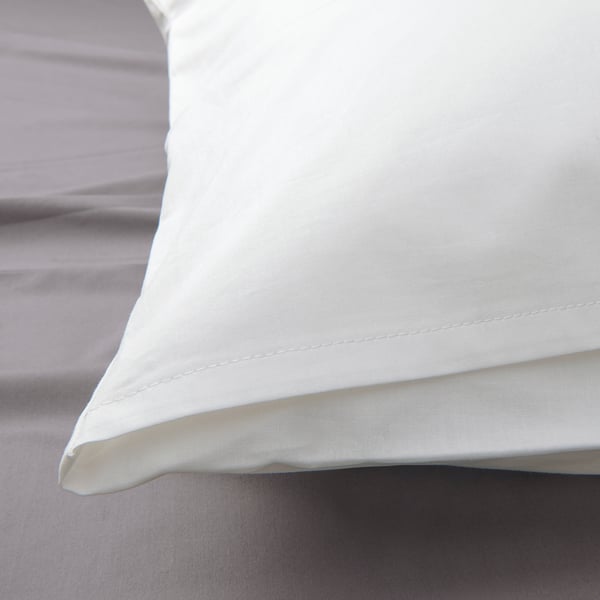 Crisp, white pillowcase showcasing high thread count, exuding durability and softness.