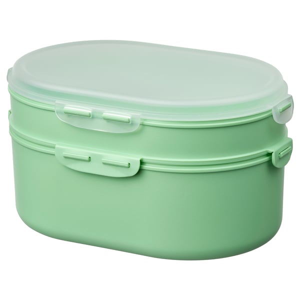 A UTBJUDA, a mint green stackable lunch box made of polypropylene plastic, with two tiers for separate food storage.