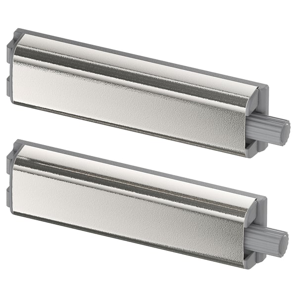 Two sleek, silver UTRUSTA push openers, made of nickel-plated steel and plastic, designed to open cabinets handle-free.