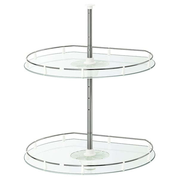 An UTRUSTA two-tier, clear glass swivel shelf organiser for corner cabinets.