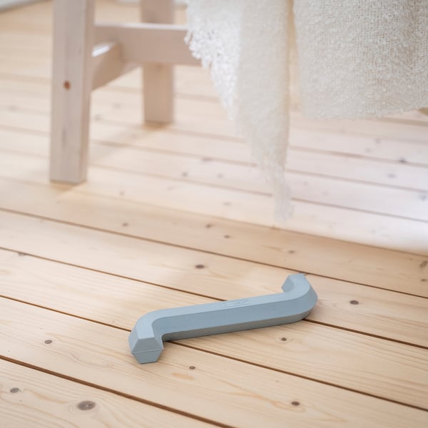 Light blue UTSÅDD dog toy on wooden floor, shaped like an allen key, small size.