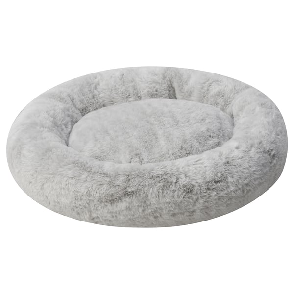 A round, soft grey UTSÅDD pet bed. Its designed for pets to curl up and relax, with a plush, calming high edge for comfort and support.