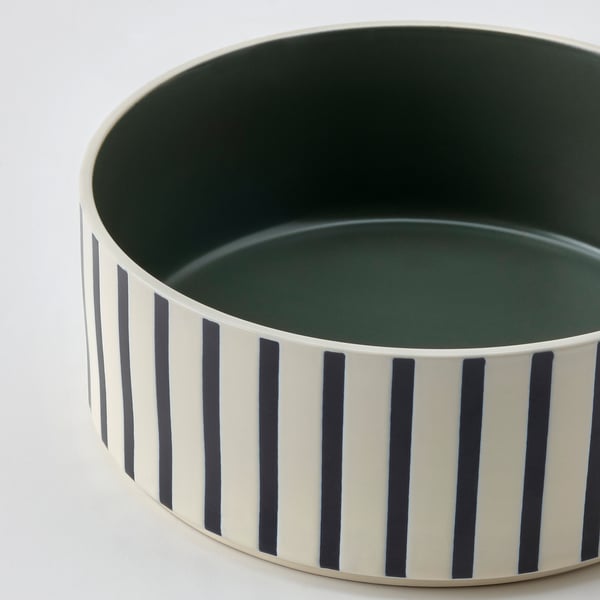 Black and white striped pet bowl, durable stoneware with green interior.