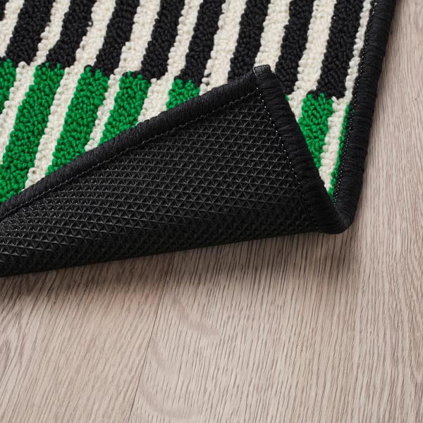Striped door mat with black rubber backing for grip.
