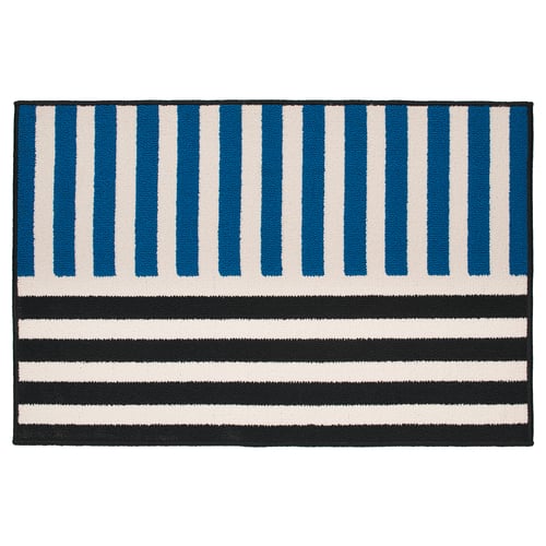 A rectangular, blue-black striped bath mat by tom hedqvist, with low pile for comfort and synthetic rubber backing for stability.